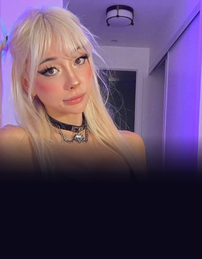 Izzy Skyee in a purple-lit room